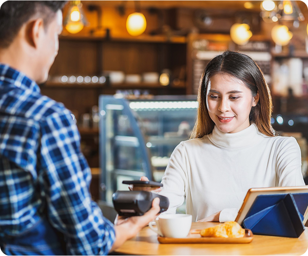 Customer paying at a café with a card reader